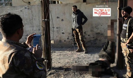 Shocking photos show Iraqi special forces soldiers posing next to body of hanged ISIS fighter as Mosul battle continues