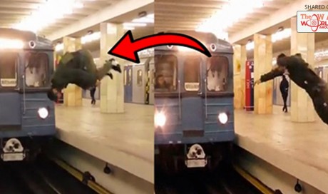 Foolish prankster risks his life by flipping in front of train