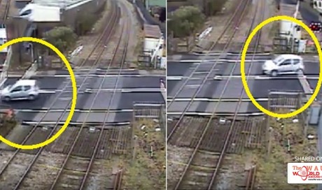 [Video] Ridiculous! Speeding car slips through closing train track barrier