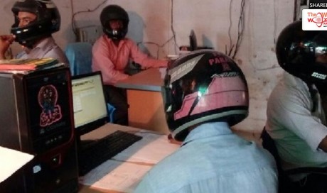Watch: Office workers in India forced to wear bike helmets because of falling ceiling
