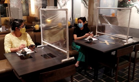 Bangkok reopens with stylists in scrubs, plastic screens between diners