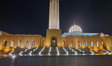 Sultan Qaboos Grand Mosque lit up in orange