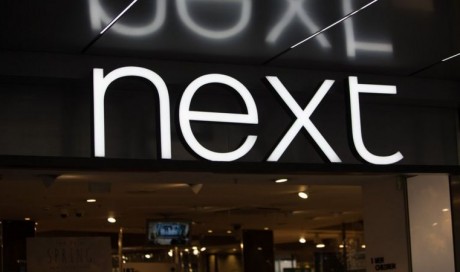Next sees online lift but store sales drop by half